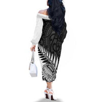 Off-shoulder long-sleeve dress in black and white with bold tribal print, side view
