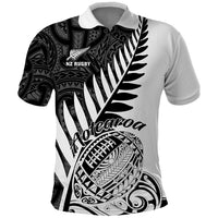 White rugby polo shirt with black Maori-style front graphic and fern motif