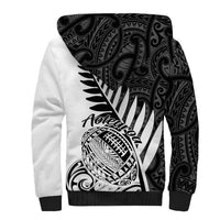 Unisex white sherpa hoodie with large black tribal print on front, black cuffs