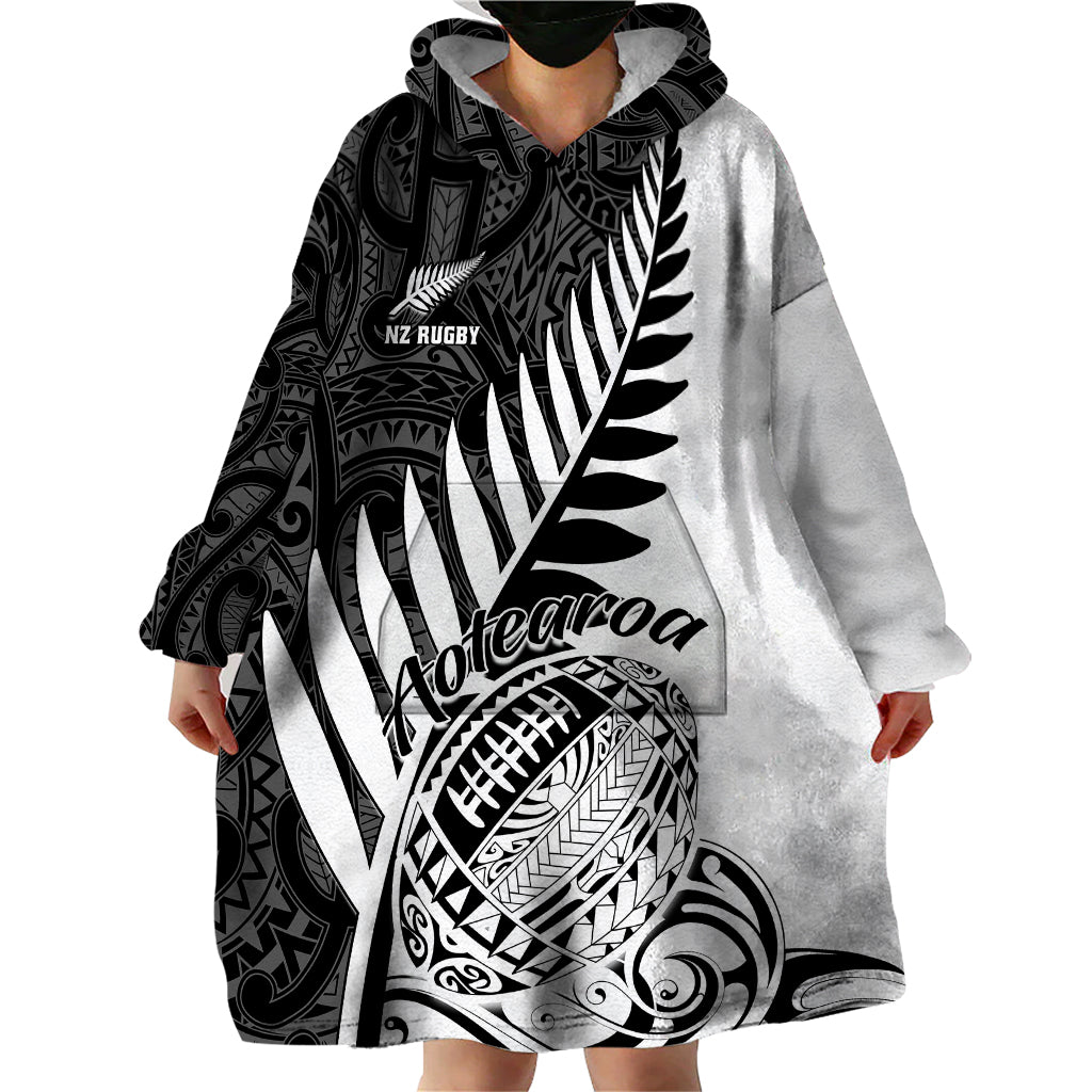 Grey and black wearable blanket hoodie with large Maori pattern and front hood