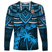 Blue long-sleeve rugby shirt with tribal geometric pattern, crest, and palm tree graphic
