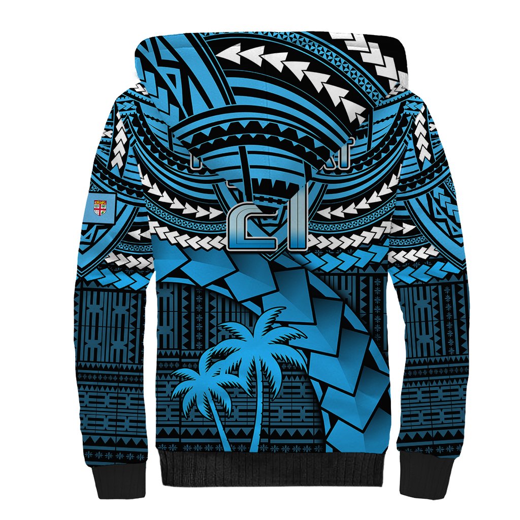 Blue sherpa-lined hoodie with large center emblem and tribal geometric pattern