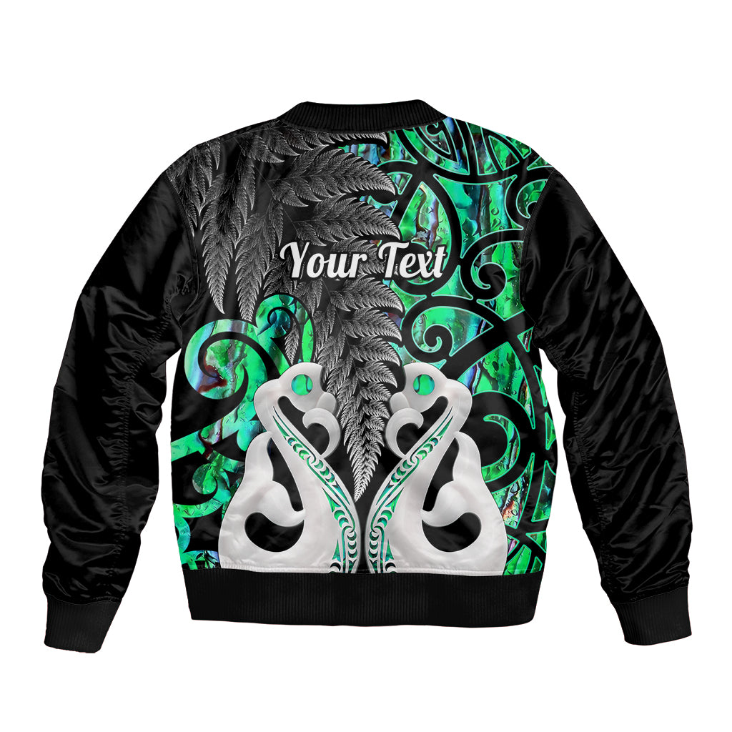 Black bomber jacket back with green tribal pattern, 'Your Text' graphic, ribbed hem