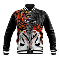 Black baseball jacket with orange and white Maori-style artwork, ribbed collar and cuffs