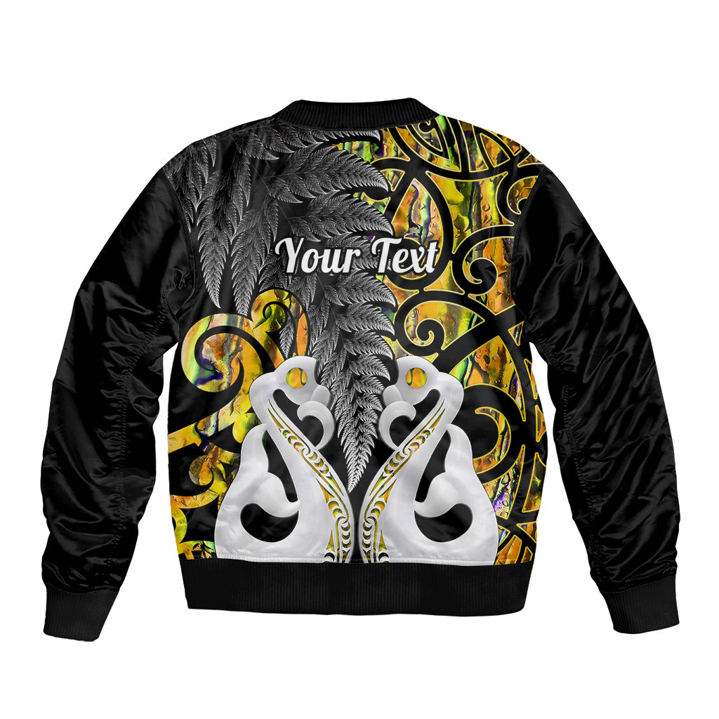 Black bomber jacket back with white tiki figures, gray fern, gold scrolls, and Your Text