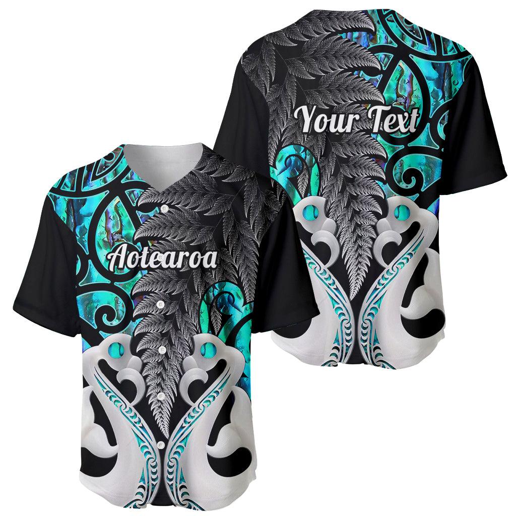 Turquoise and black baseball jersey with fern and tiki patterns, front and back views