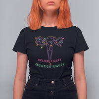 Women's black graphic T-shirt with colorful lights and uterus-themed message