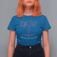 Women's royal blue graphic T-shirt with colorful lights and uterus-themed message