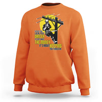 Orange crewneck sweatshirt with yellow pole dancer graphic on the front.