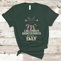 Dark forest green T-shirt with colorful feather arrow graphic and “Columbus Indigenous People’s Day” text