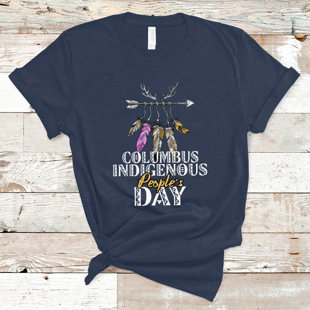 Navy T-shirt with colorful feather arrow graphic and “Columbus Indigenous People’s Day” text