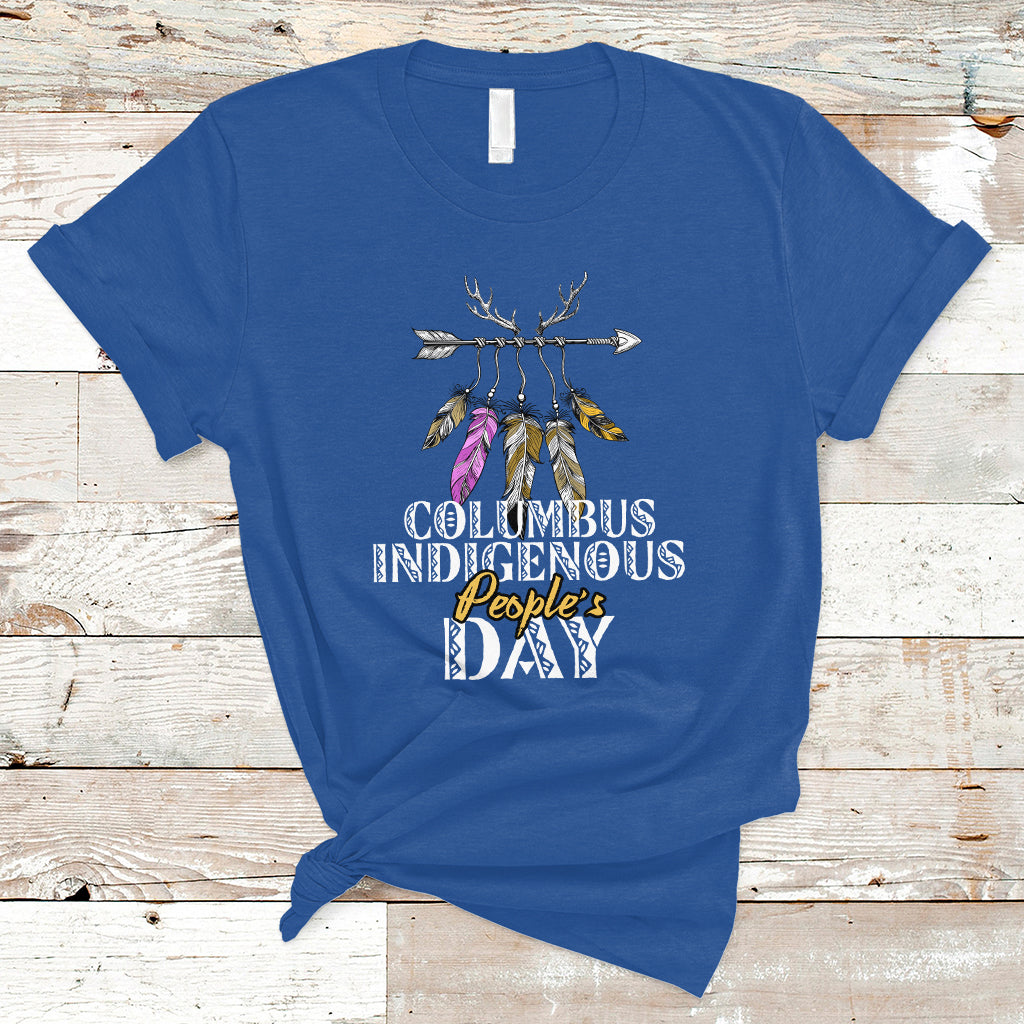 Royal blue T-shirt with colorful feather arrow graphic and “Columbus Indigenous People’s Day” text