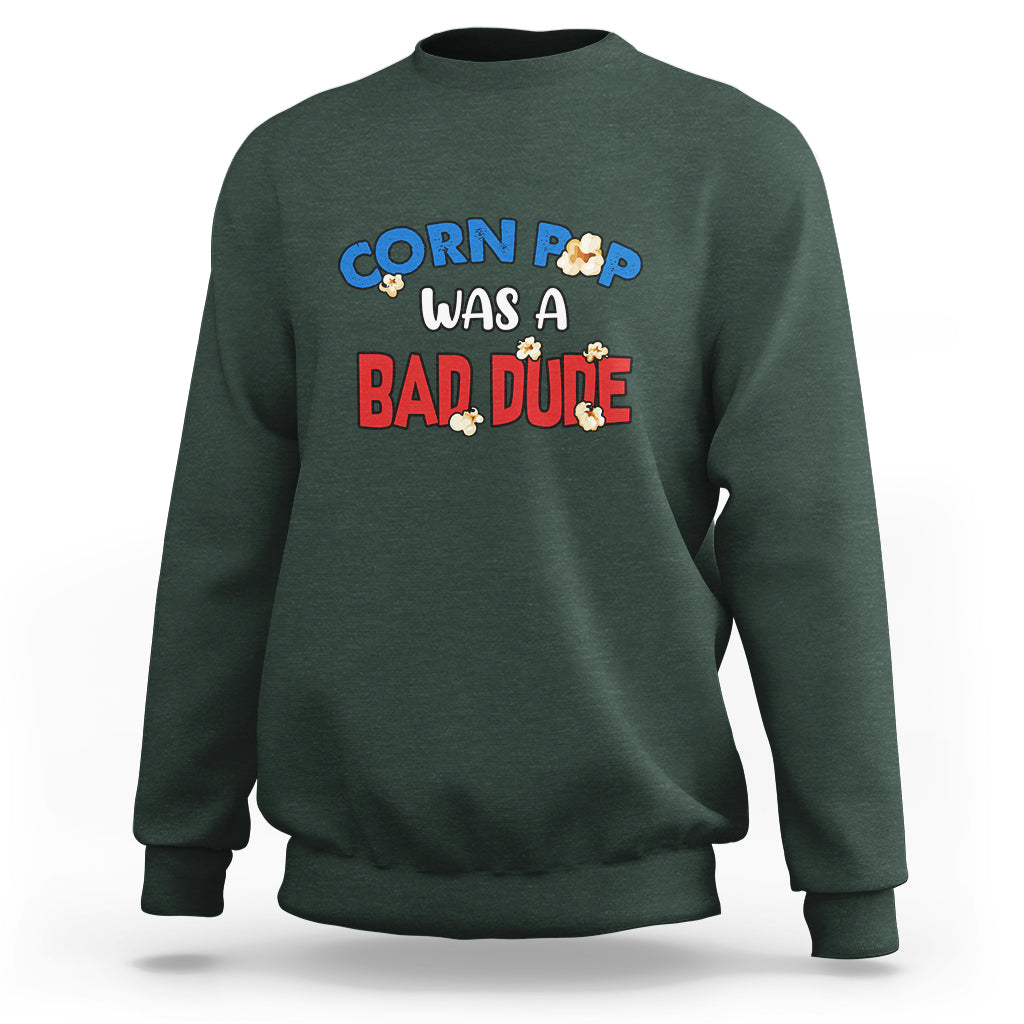 Dark forest green sweatshirt with “Corn Pop was a bad dude” graphic on the front