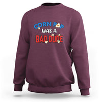 Maroon sweatshirt featuring the “Corn Pop was a bad dude” chest graphic