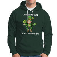 Dark forest green St. Patrick's Day hoodie with leprechaun graphic and 'I PAUSED MY GAME' text.