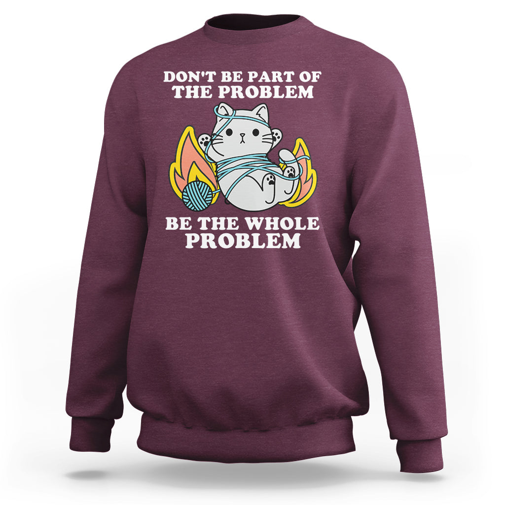 Maroon crewneck sweatshirt with cat graphic and 'BE THE WHOLE PROBLEM' text