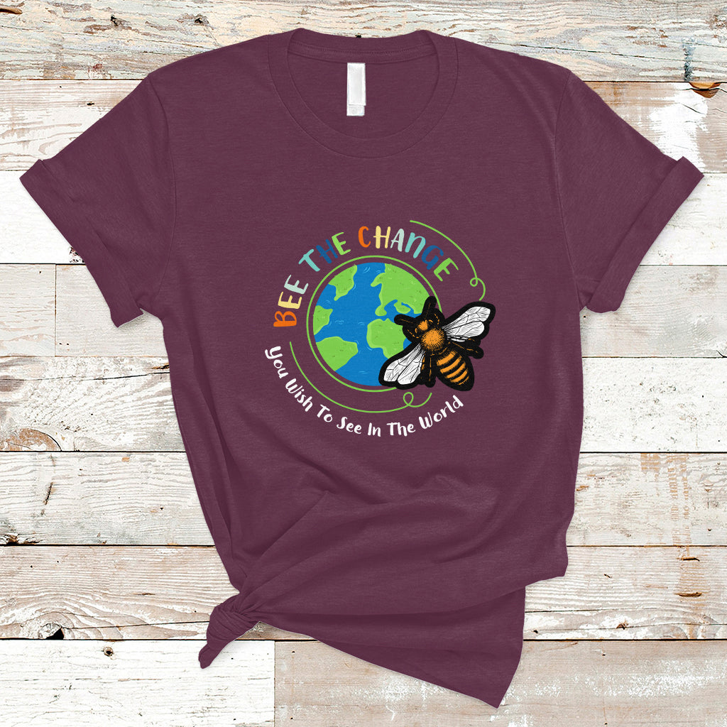 Maroon T-shirt with circular bee and globe graphic and slogan