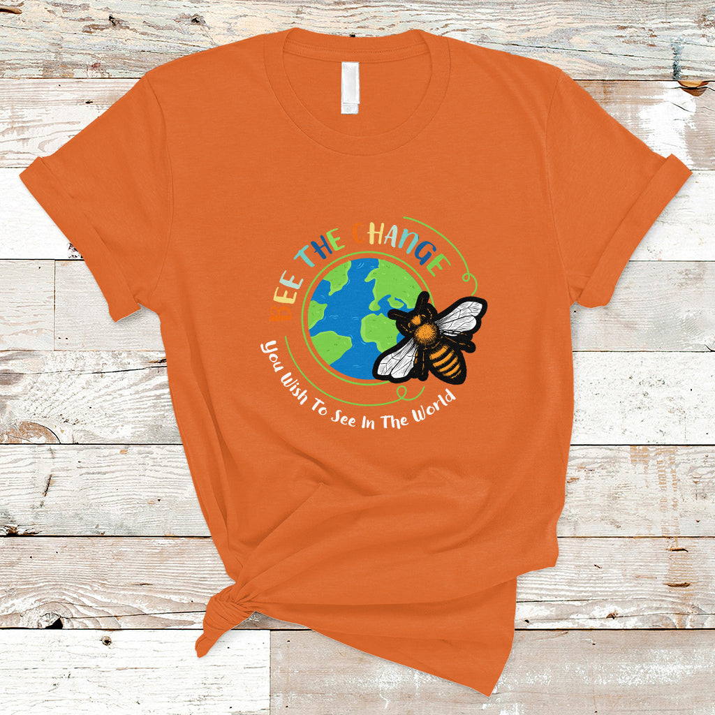 Orange T-shirt with circular bee and globe graphic and slogan