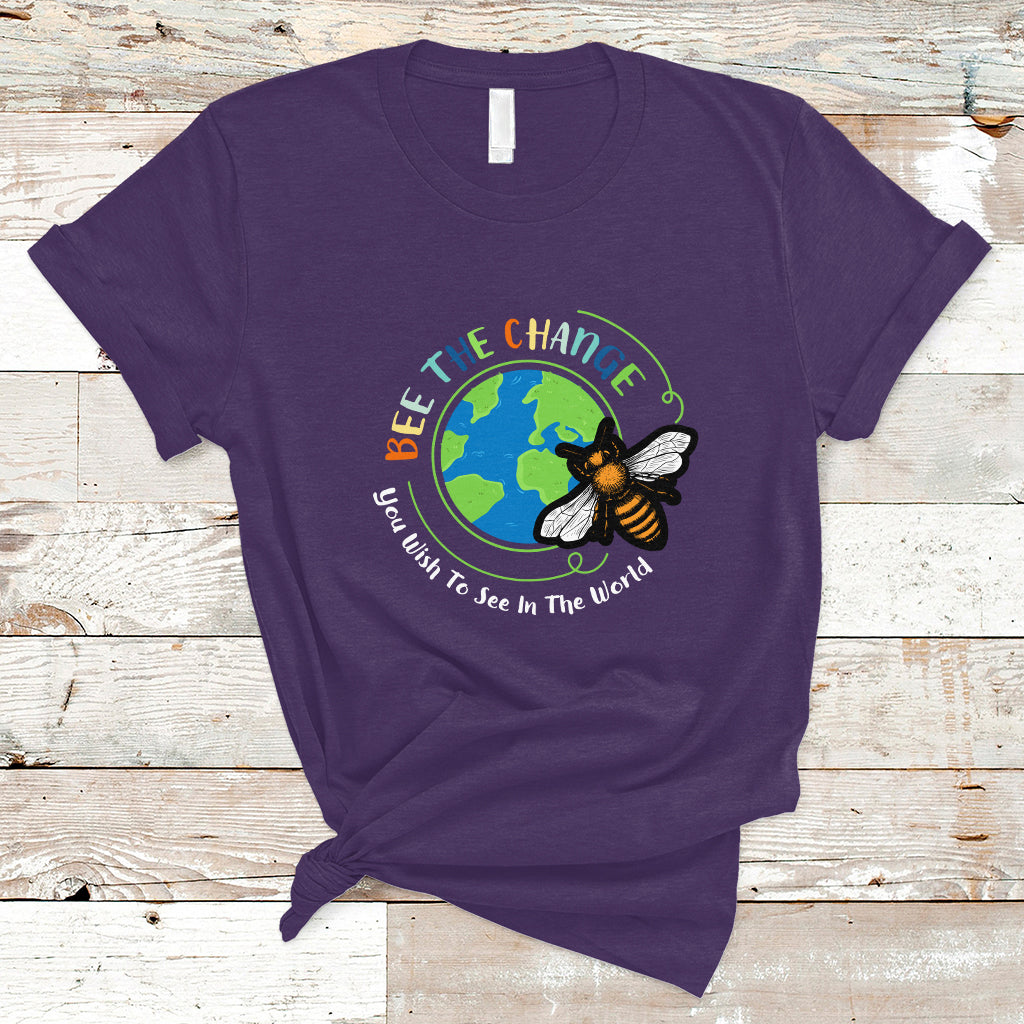 Purple T-shirt with circular bee and globe graphic and slogan