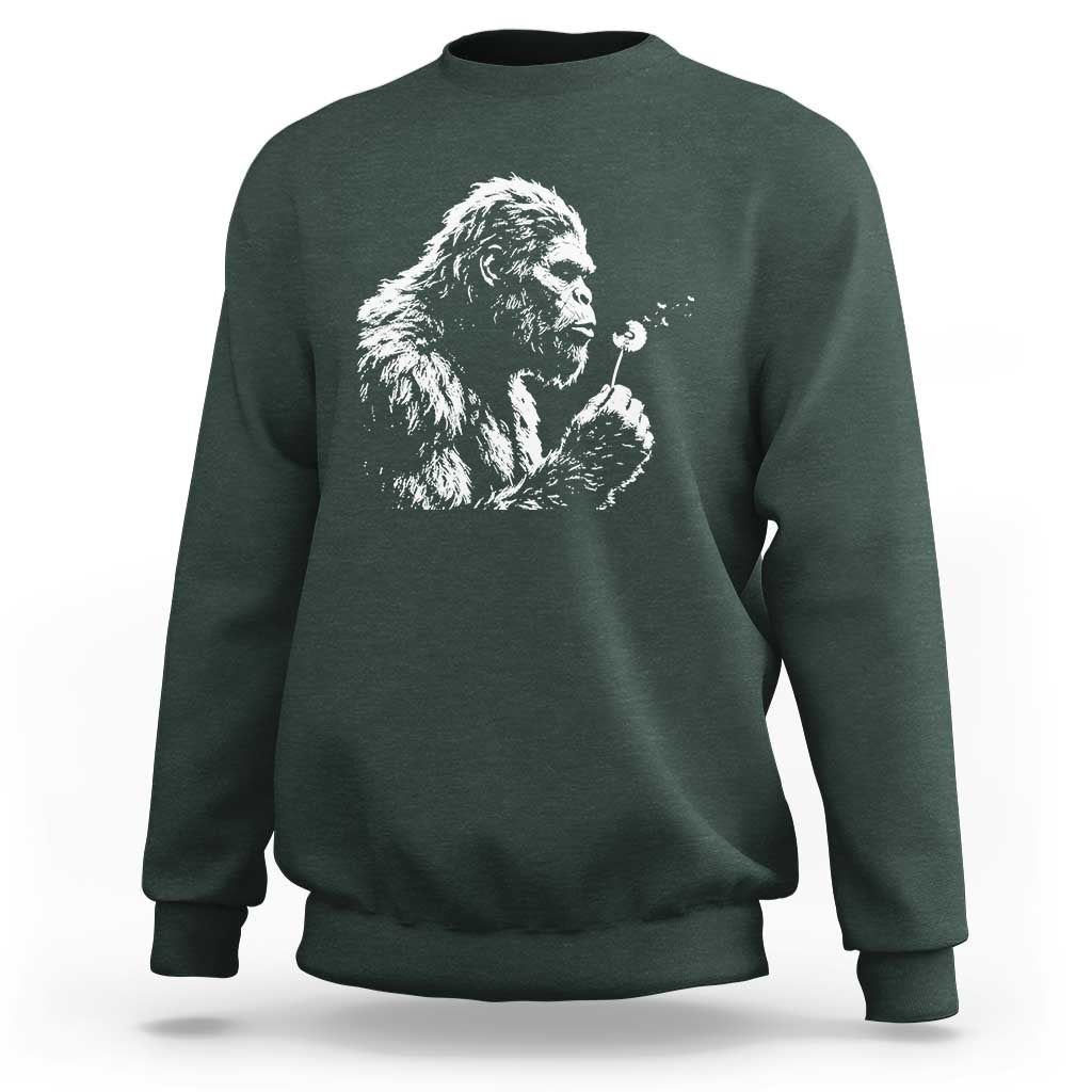 Bigfoot Blowing Dandelion Flower Graphic Sweatshirt Whimsical Sasquatch Profile Artistic Vintage Distressed