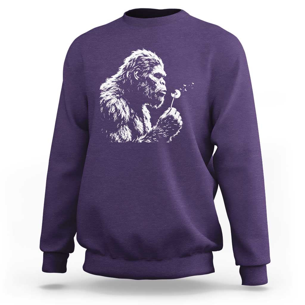 Bigfoot Blowing Dandelion Flower Graphic Sweatshirt Whimsical Sasquatch Profile Artistic Vintage Distressed