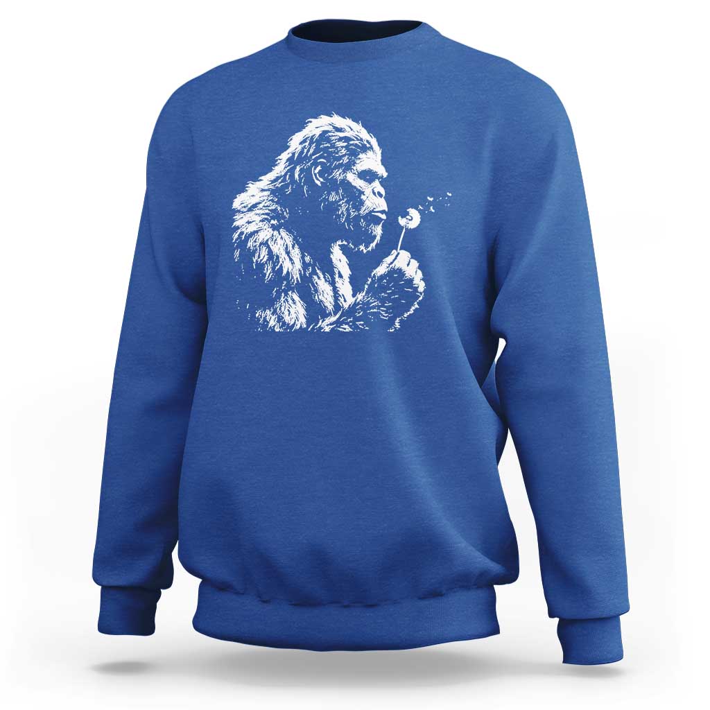 Bigfoot Blowing Dandelion Flower Graphic Sweatshirt Whimsical Sasquatch Profile Artistic Vintage Distressed