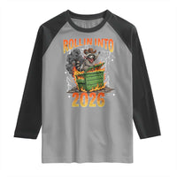 Dumpster Fire Raccoon Meme for Surviving 2025 Raglan Shirt Rollin Into 2026 Trash Panda Energy - Wonder Print Shop