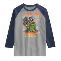 Dumpster Fire Raccoon Meme for Surviving 2025 Raglan Shirt Rollin Into 2026 Trash Panda Energy - Wonder Print Shop