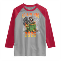 Dumpster Fire Raccoon Meme for Surviving 2025 Raglan Shirt Rollin Into 2026 Trash Panda Energy - Wonder Print Shop