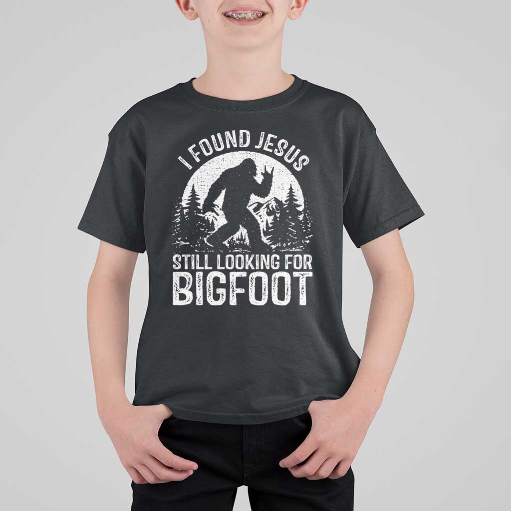 Funny Christian Sasquatch T Shirt For Kid I Found Jesus Still Looking for Bigfoot Vintage Distressed Graphic