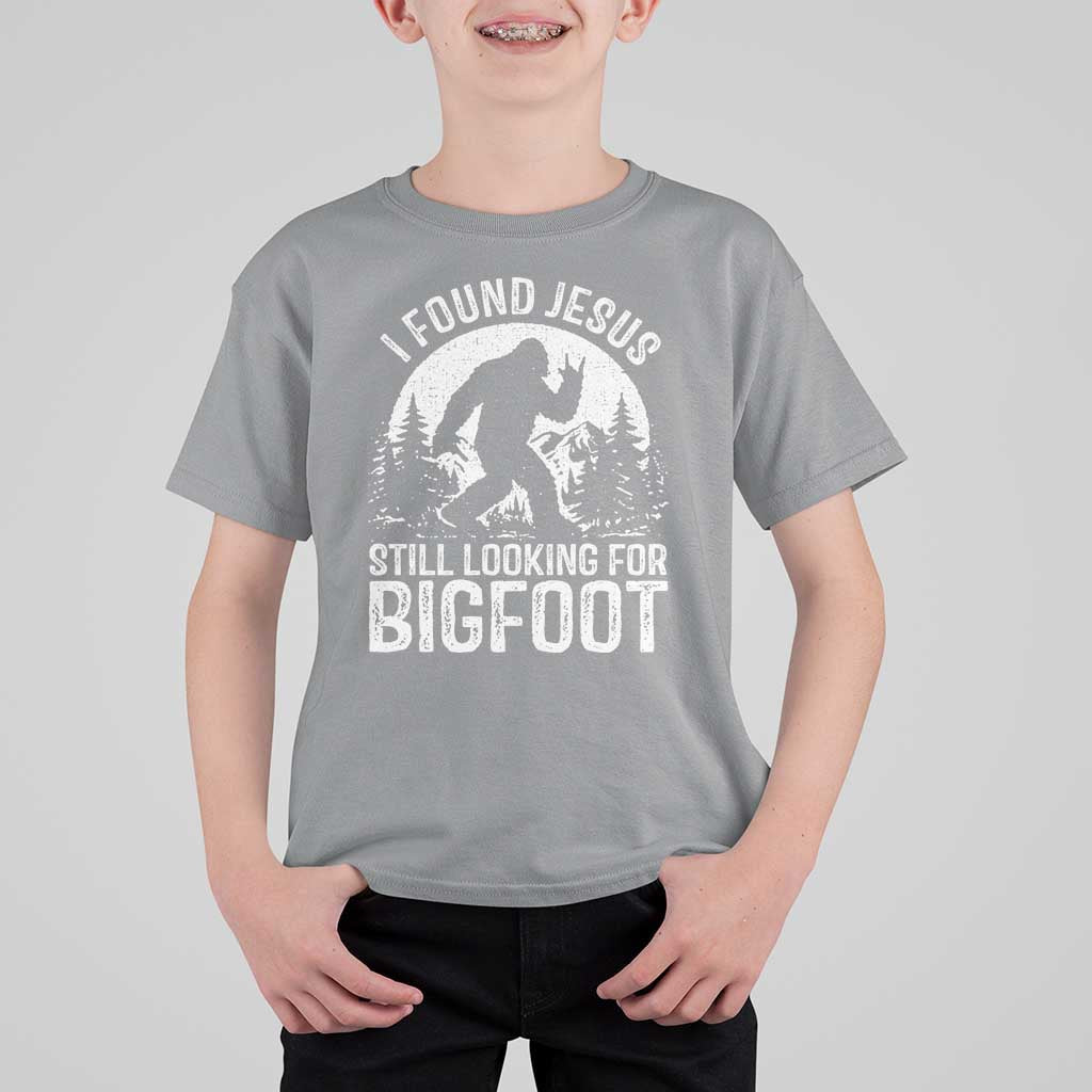 Funny Christian Sasquatch T Shirt For Kid I Found Jesus Still Looking for Bigfoot Vintage Distressed Graphic
