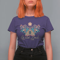 Women's purple graphic t-shirt with colorful moth, sun, and 'Wild Soul' print