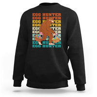 Kids long-sleeve crewneck sweatshirt, black; Bigfoot egg hunter graphic with baskets