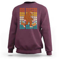 Kids long-sleeve crewneck sweatshirt, maroon; Bigfoot egg hunter graphic with baskets