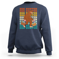 Kids long-sleeve crewneck sweatshirt, navy; Bigfoot egg hunter graphic with baskets