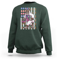 Kids dark forest green sweatshirt with Bigfoot in bunny costume holding Easter eggs graphic