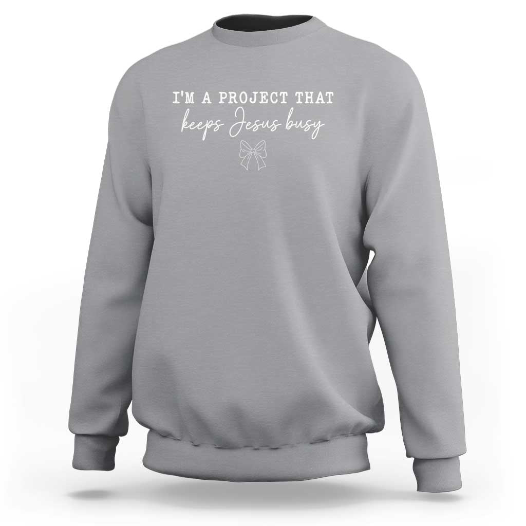 I am a Project That Keeps Jesus Busy Coquette Bow Sweatshirt Christian Faith Humor