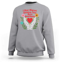 I Hear Migrant Children Also Have Heartbeats Sweatshirt Groovy Retro Floral Hands Heart Social Justice
