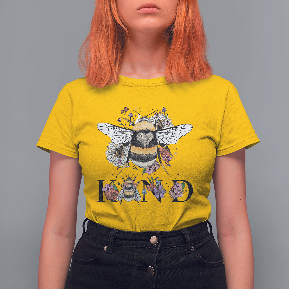 Women's yellow crewneck t-shirt with bee-and-floral retro graphic and BE KIND print