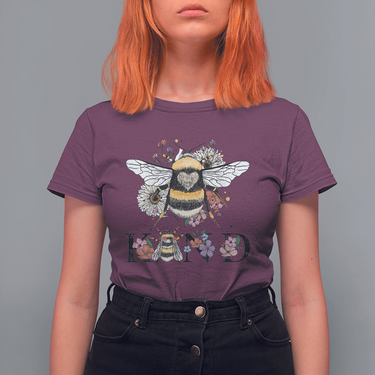 Women's purple crewneck t-shirt with bee-and-floral retro graphic and BE KIND print