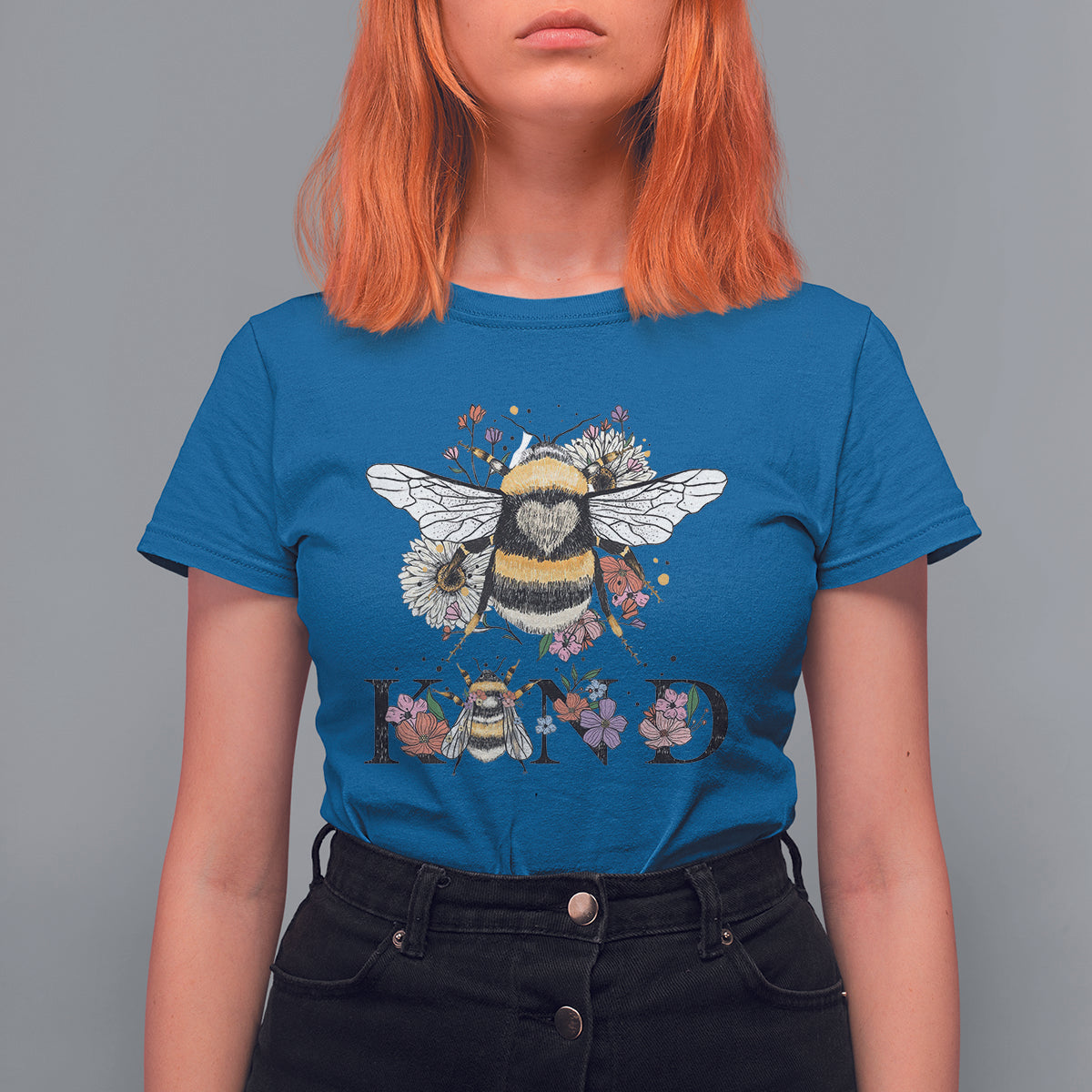 Women's blue crewneck t-shirt with bee-and-floral retro graphic and BE KIND print
