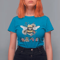 Women's teal blue crewneck t-shirt with large bee-and-floral retro graphic and BE KIND print