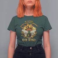 Dark forest green "Bee Kind" T-shirt with large floral bee graphic on chest