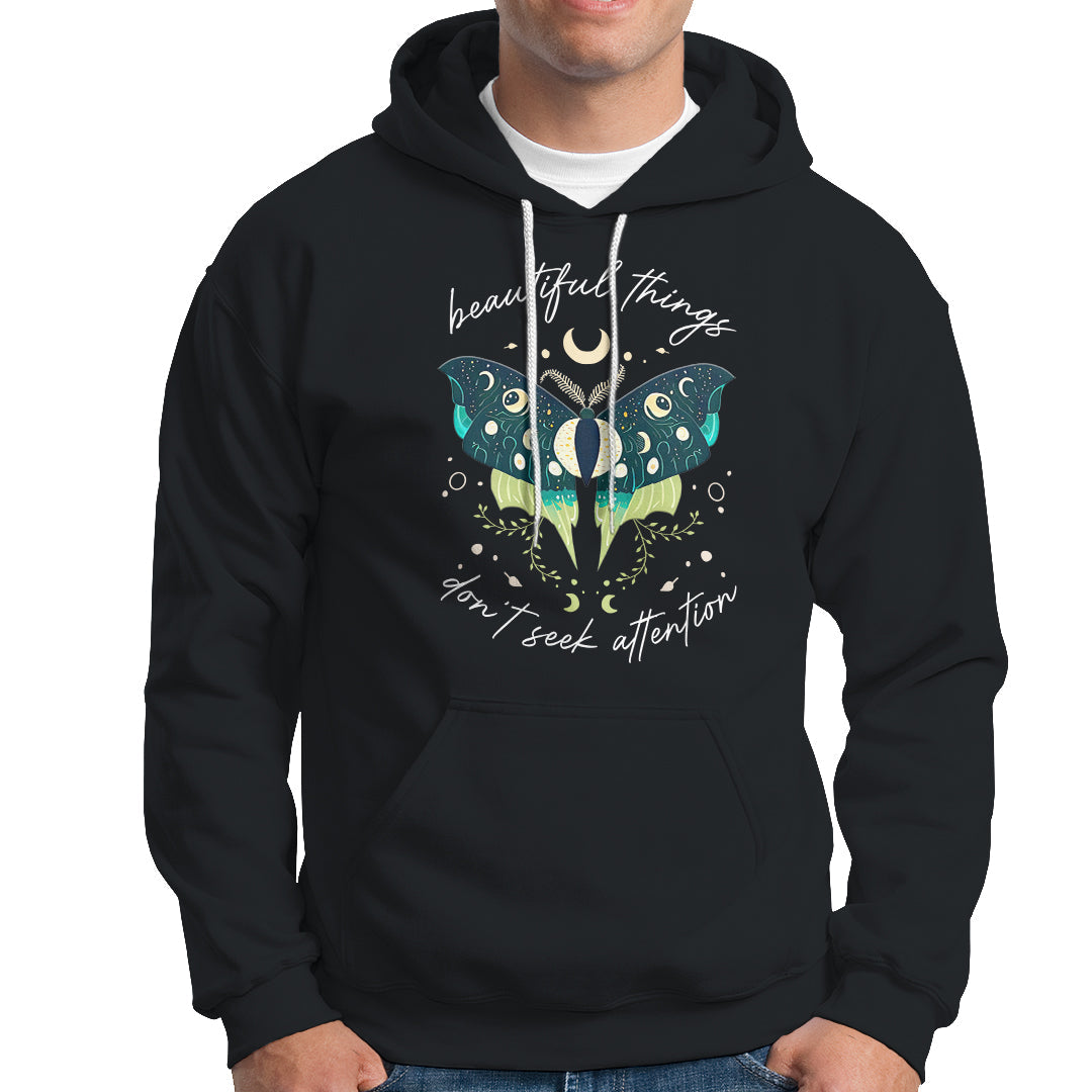 Black women's hoodie with hood and front pocket; turquoise moth crescent moon graphic.