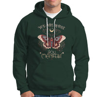 Dark forest green hoodie with front moth graphic and "You Are What You Manifest" text