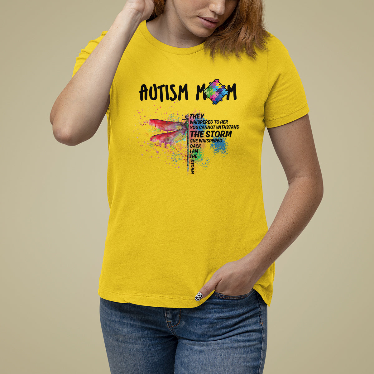Women's autism awareness graphic T-shirt, yellow, rainbow puzzle dragonfly and "storm" text