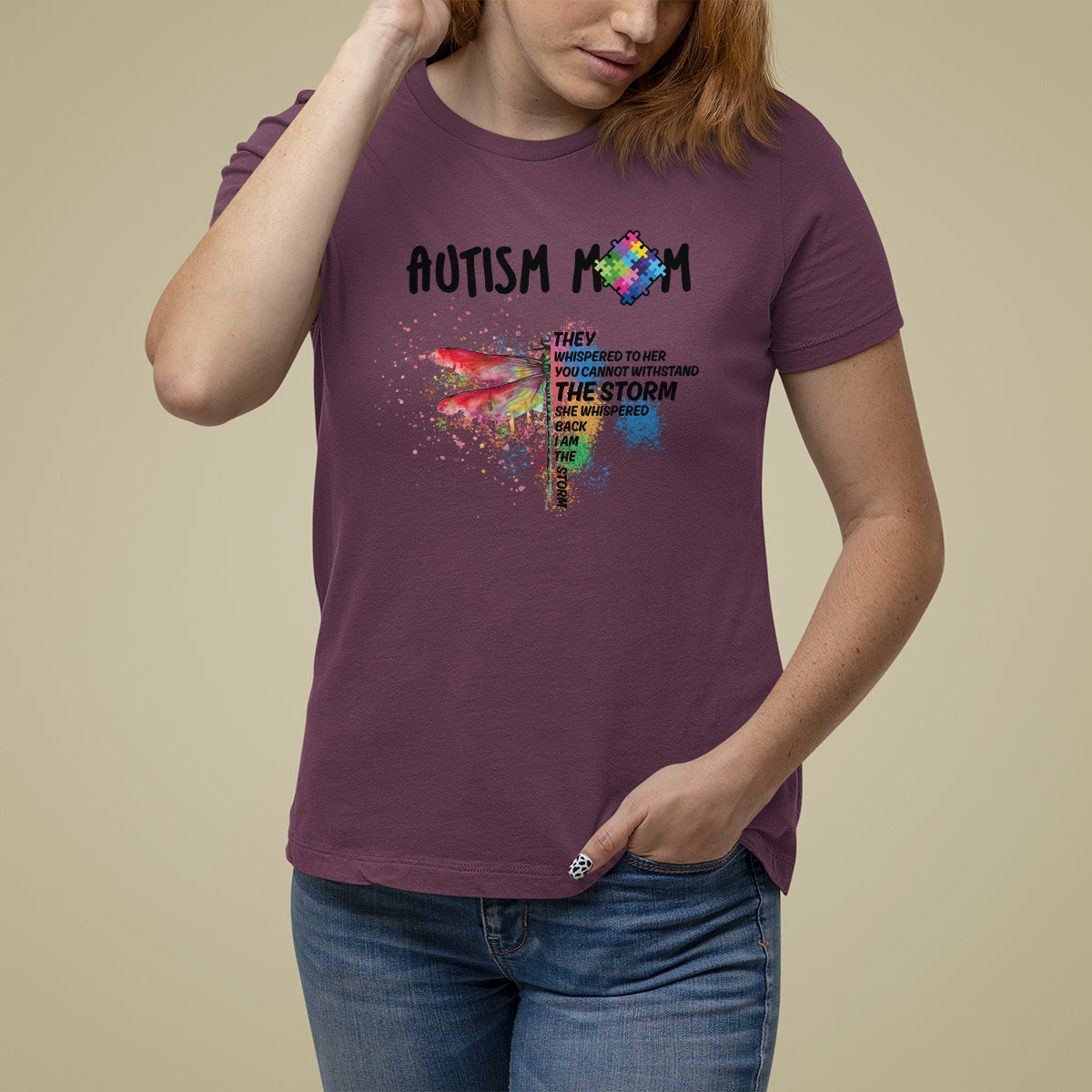 Women's autism awareness graphic T-shirt, maroon, rainbow puzzle dragonfly and "storm" text