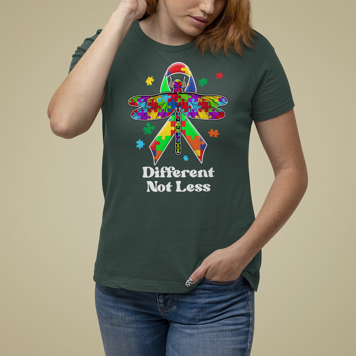 Dark forest green autism awareness T-shirt with colorful puzzle dragonfly graphic and “Different Not Less”