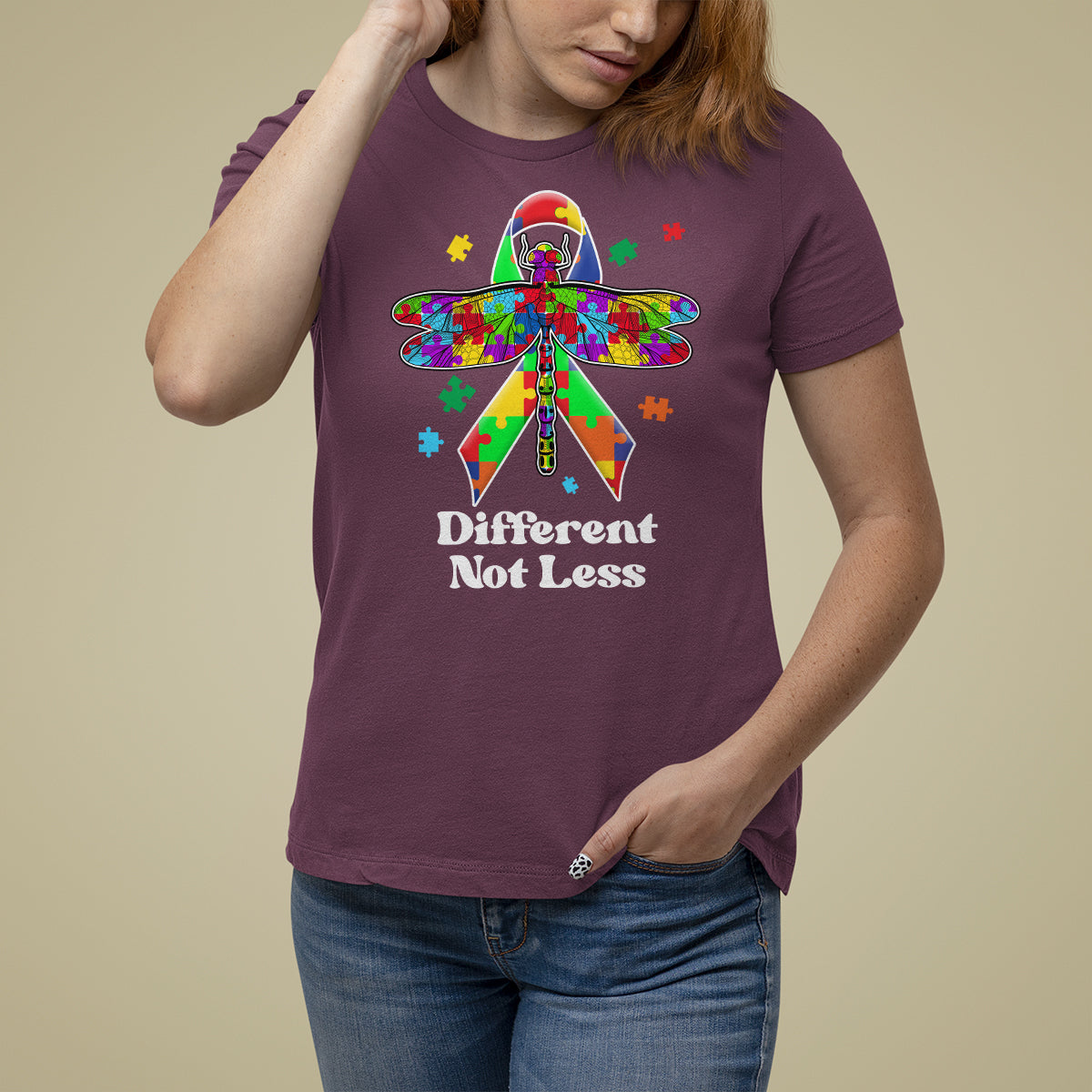 Maroon autism awareness T-shirt with colorful puzzle dragonfly graphic and “Different Not Less”