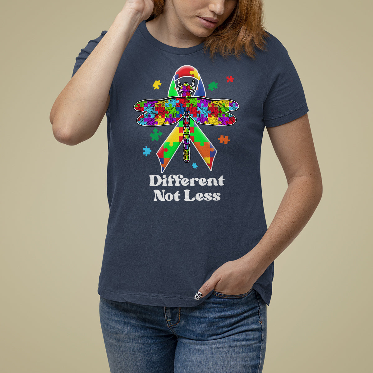Navy autism awareness T-shirt with colorful puzzle dragonfly graphic and “Different Not Less”